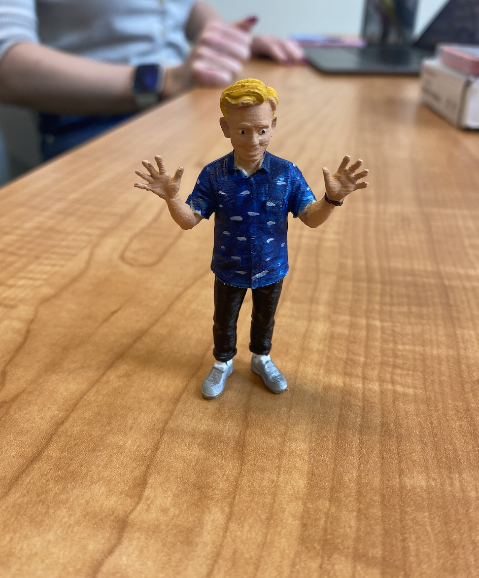 Custom 3D printed figurine of a person made from a photo, standing on a small base