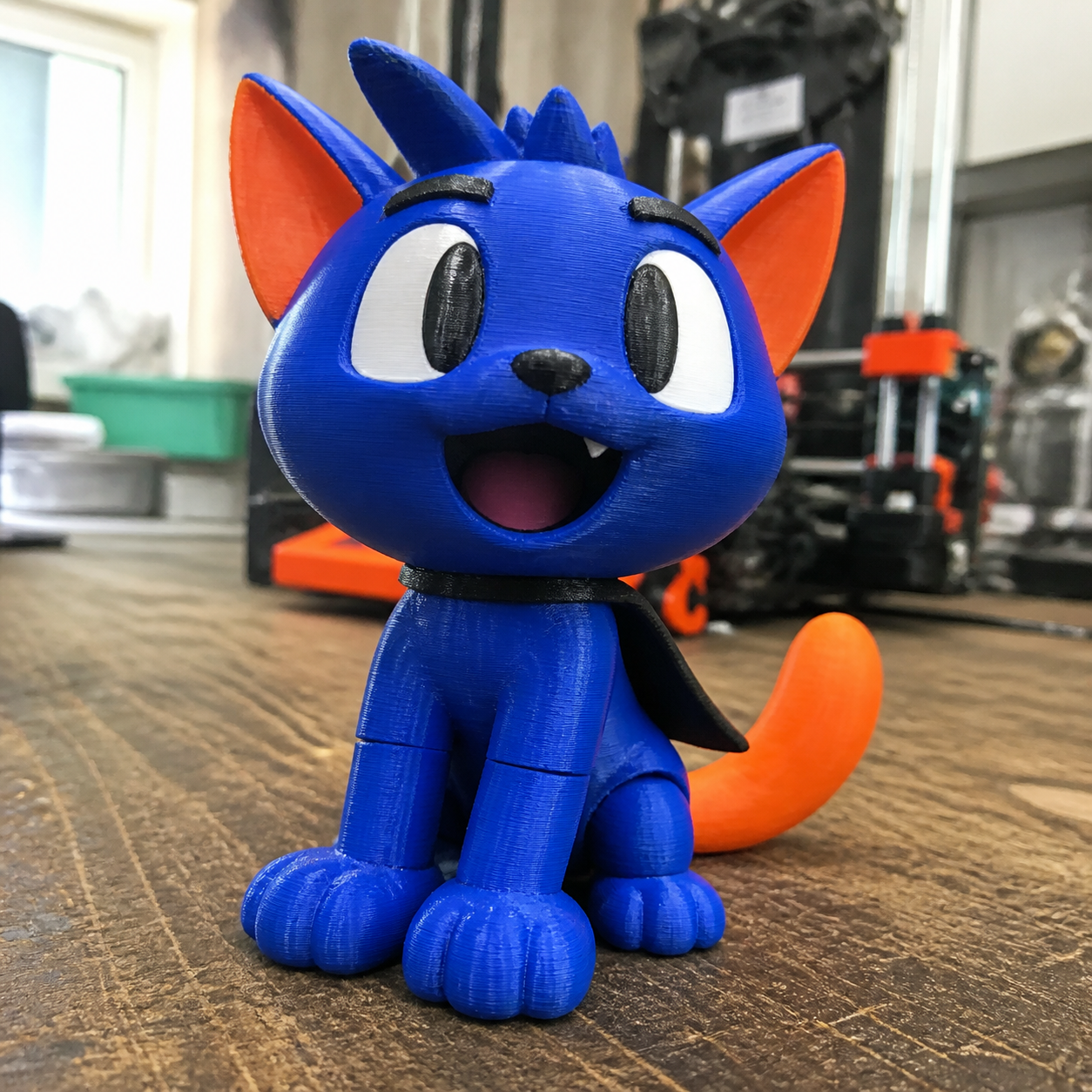 Mega Cat, a blue and orange 3D-printed cat Artwork Figure with oversized paws and a tiny cape
