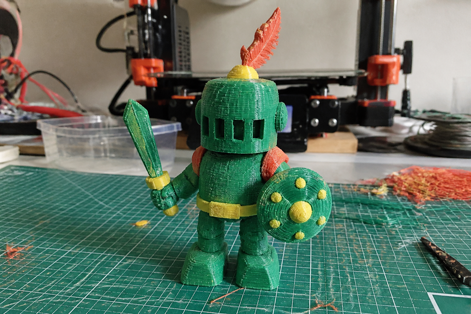 The Green Knight, a handmade green 3D-printed Artwork Figure holding a sword and round shield